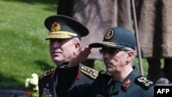 Chief of Staff of the Armed Forces of Iran, Mohammad Bagheri (R) salutes the honor guards as he is welcomed by Chief of the General Staff of the Turkish Armed Forces Hulusi Akar during his official visit to Ankara, August 15, 2017