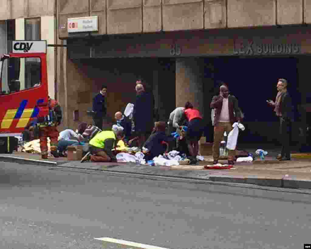 Emergency personnel tend injured people after the explosion at Maelbeek station.