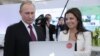 Russia -- President Vladimir Putin and Russia Today (RT) editor-in-chief Margarita Simonyan attend an exhibition marking the 10th anniversary of RT, December 10, 2015.