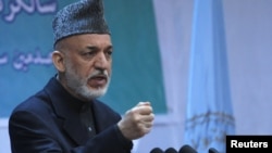 Afghan President Hamid Karzai speaks during a gathering in Kabul on April 17.