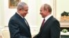 Russian President Vladimir Putin, right, shakes hands with Israeli Prime Minister Benjamin Netanyahu during their meeting at the Kremlin in Moscow, Wednesday, July 11, 2018. (Yuri Kadobnov/ Pool photo via AP)