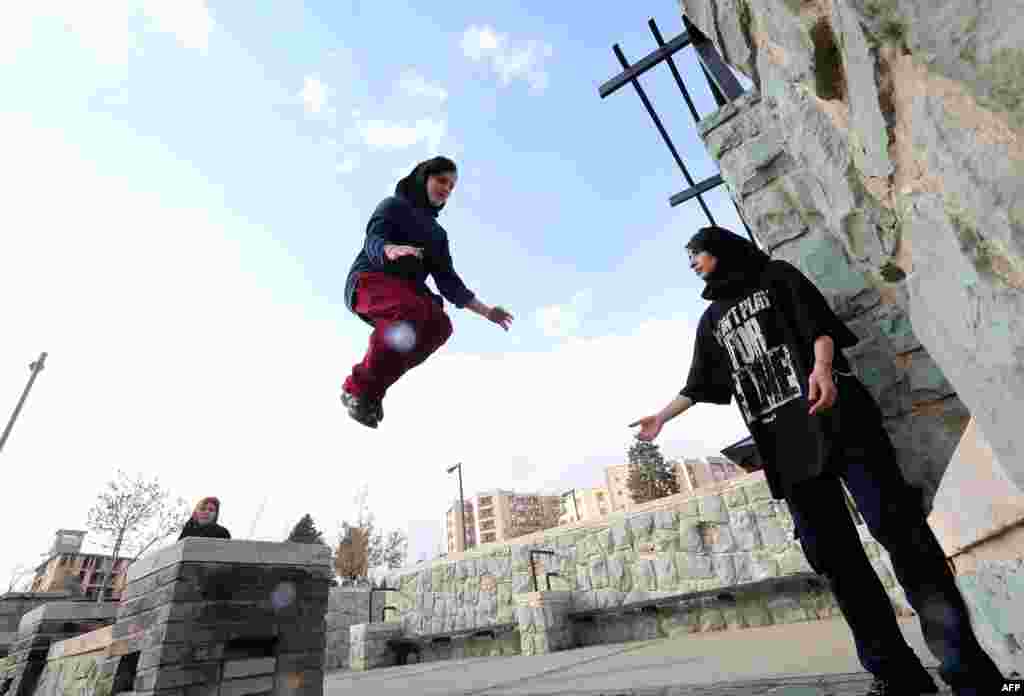 Iranian women test their vertical leap in Tehran&#39;s Tavalod Park.