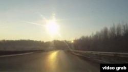 A still from a dashcam video from Chelyabinsk as the meteor streaks over the highway in February.