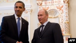 Freedom House has urged U.S. President Barack Obama (left) to "think twice" before traveling to Russia to meet President Vladimir Putin before September's G20 summit.