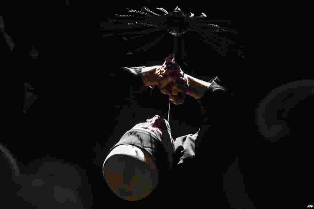 A Kosovo dervish pierces his neck with a needle during a ceremony in Prizren during Norouz celebrations. The Kosovo dervish community carries on such centuries-old mystical practices as a way to earn salvation and find the path to God. Norouz is an ancient Persian festival marking the first day of spring. (AFP/Armend Nimani)