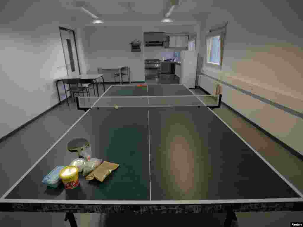 Food is left on a pingpong table in a kitchen in one of the wings of the Detention Unit.