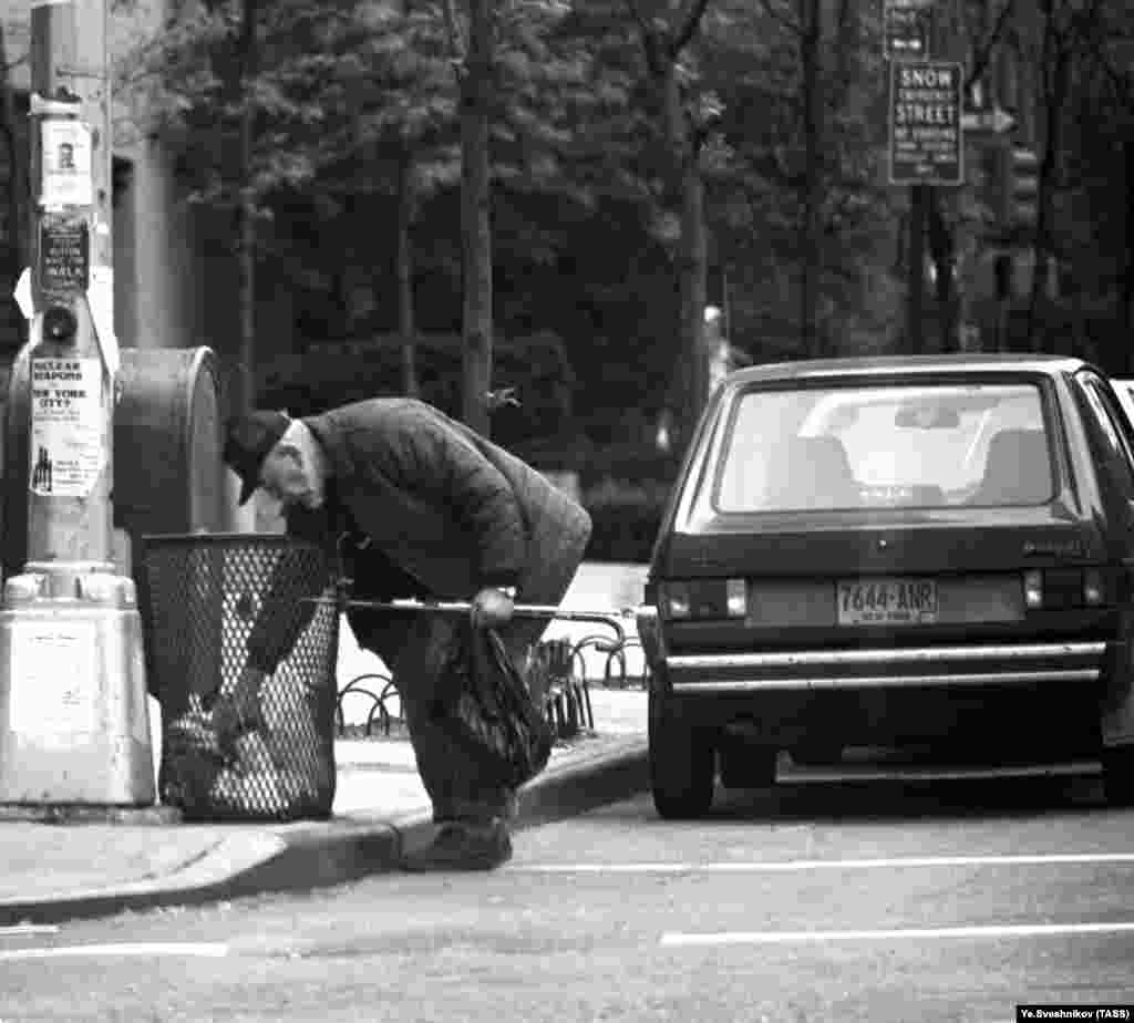 This 1985 image of a man picking through a trash can in New York is one of many pictures in the archive focusing on American poverty. 
