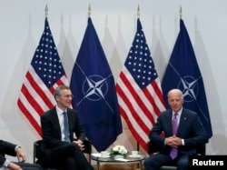 Then-U.S. Vice President Joe Biden (right) meets with NATO Secretary-General Jens Stoltenberg during the 51st Munich Security Conference in Munich in February 2015.