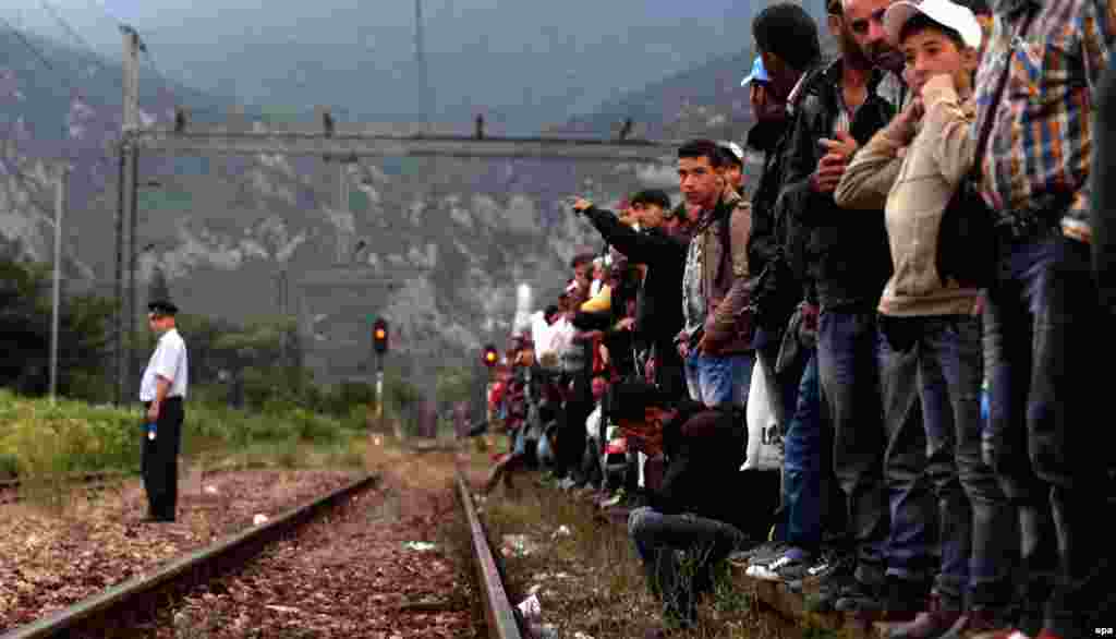 Migrants wait for a train to Serbia on the track near a train station in Demi Kapija, Macedonia, on June 18. (epa/Nake Batev)