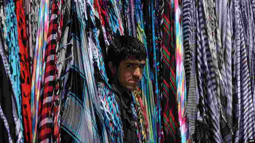 An Afghan scarf vendor waits for custumers in downtown Kabul on May 31. (AFP/Aref Karimi)&nbsp;