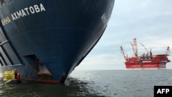 Greenpeace activists attach themselves to the anchor of the Anna Akhmatova, a Russian Arctic rig support vessel.