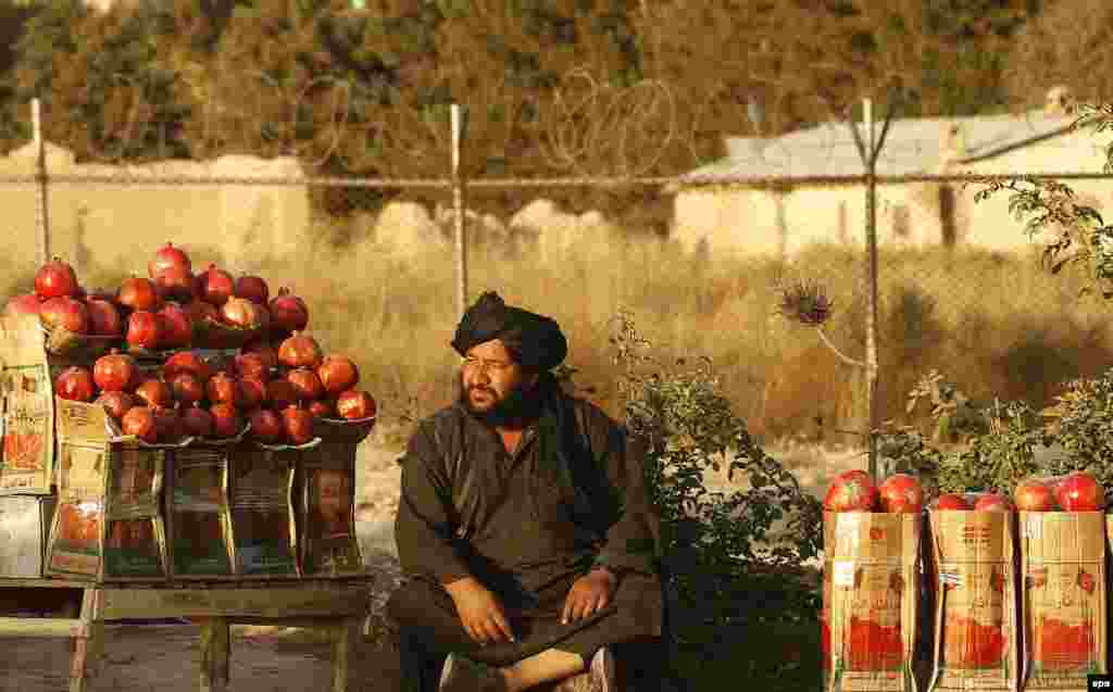 An Afghan man sells pomegranates at a roadside in Kabul. (epa/Jawad Jalali)