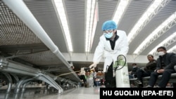 A worker disinfects a railway station in Nanchang City, China, as part of efforts to halt the spread of the coronavirus COVID-19. 