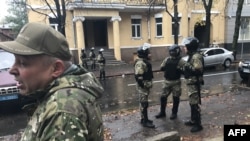 A special police unit stands guard near the apartment of Ukrainian Interior Minister Arsen Avakov’s son, Oleksandr, who was reportedly detained in Kharkiv on October 31. 