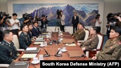 SOUTH KOREA -- South Korean chief delegate Major General Kim Do-gyun (2nd L) speaks with his North Korean counterpart An Ik San (2nd R) during their general-level military talks at the South side of the truce village of Panmunjom, July 31, 2018