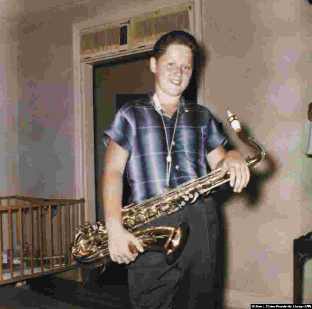 Former U.S. President Bill Clinton at home with his saxophone in Arkansas in 1958