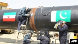 Иран жұмысшылары Иран-Пәкістан газ құбырын тартып жатыр. 