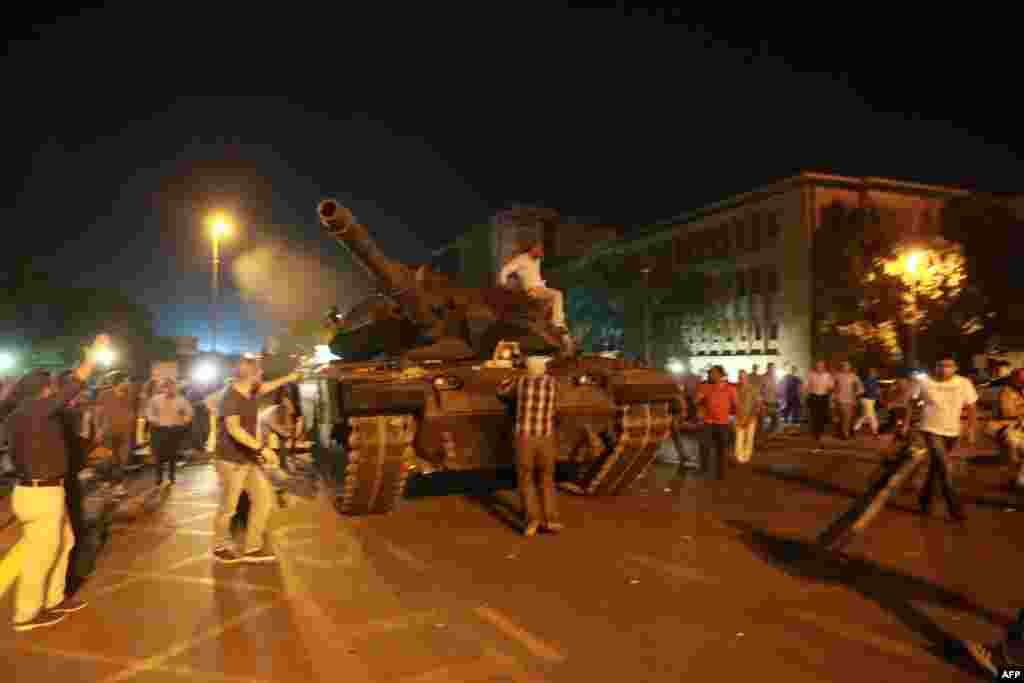 People try to take over a tank in Ankara. In an address to Turkish television, Erdogan had urged people to take to the streets.&nbsp;