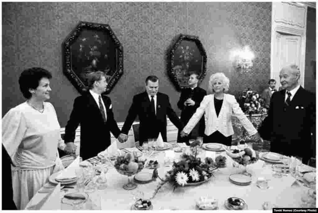 Havel and his wife, Olga, hold hands in prayer with Polish President Lech Walesa at Prague Castle on September 16, 1991.