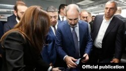 Armenia -- Prime Minister Nikol Pashinian (C) visits new textile factories opened by businessman Samvel Aleksanian (R), Yerevan, November 1, 2019. 