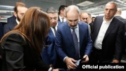 Armenia -- Prime Minister Nikol Pashinian (C) visits new textile factories opened by businessman Samvel Aleksanian (R), Yerevan, November 1, 2019.