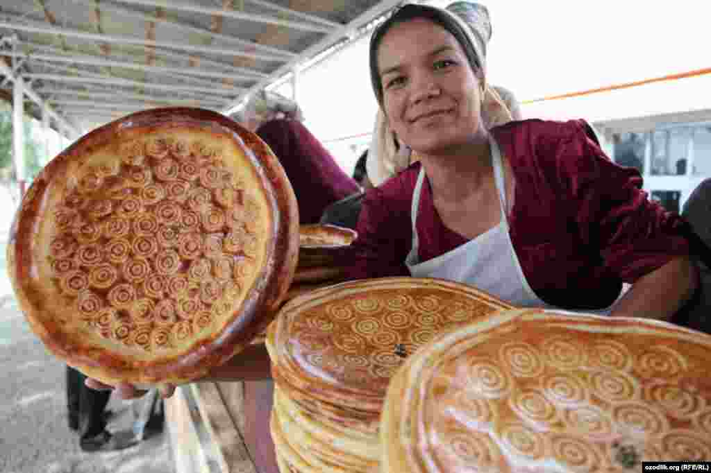 An Uzbek woman shows off her bread, called "patir," in a bazaar close to Kokand city. Patir is very hard and can be stored for a long time. The bread is usually baked by men and sold by women. The road from the Ferghana Valley to the capital, Tashkent, passes through Kokand. (RFE/RL)