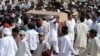 Ahmadi community members carry a coffin during a funeral ceremony in 2010 for victims of a militant attack on one of the sect's prayer halls, which killed some 80 people. According to a new report by the U.S. State Department, the religious minority Ahmadis are still the target of frequent sectarian violence.