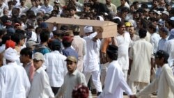 Ahmadi community members carry the coffin of a victim of an attack by gunmen wearing suicide vests on two Ahmadi mosques, during a funeral ceremony in Rabwah in May 2010