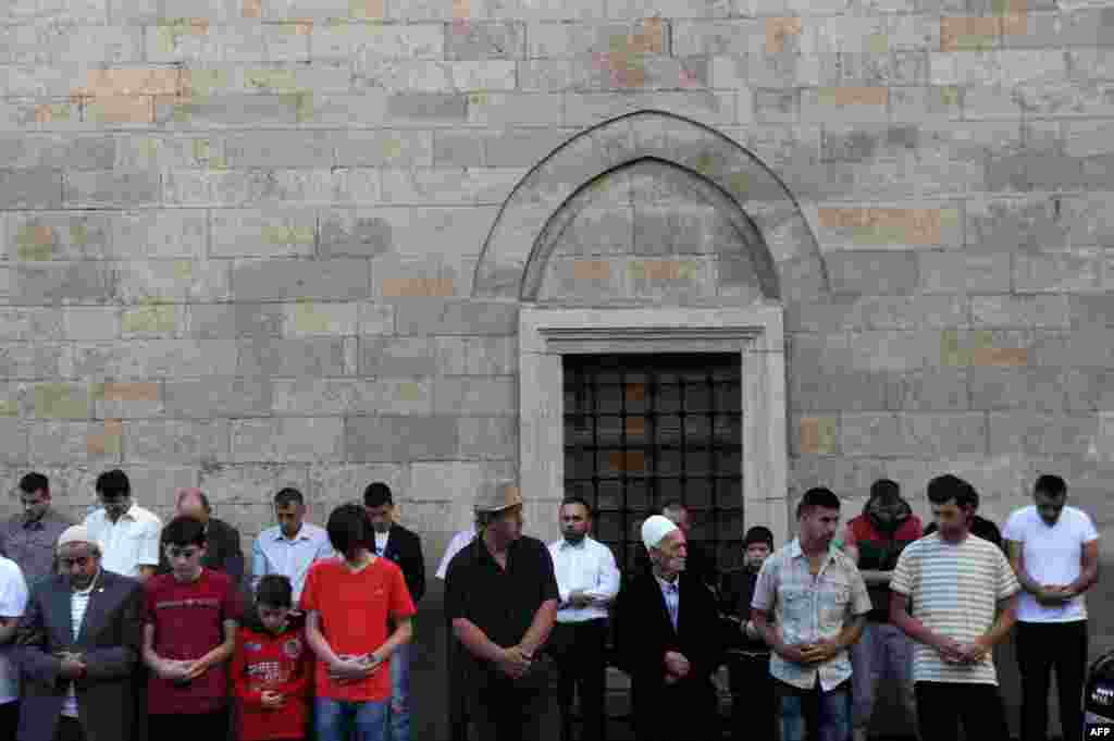 Men pray at a mosque in Pristina, Kosovo.