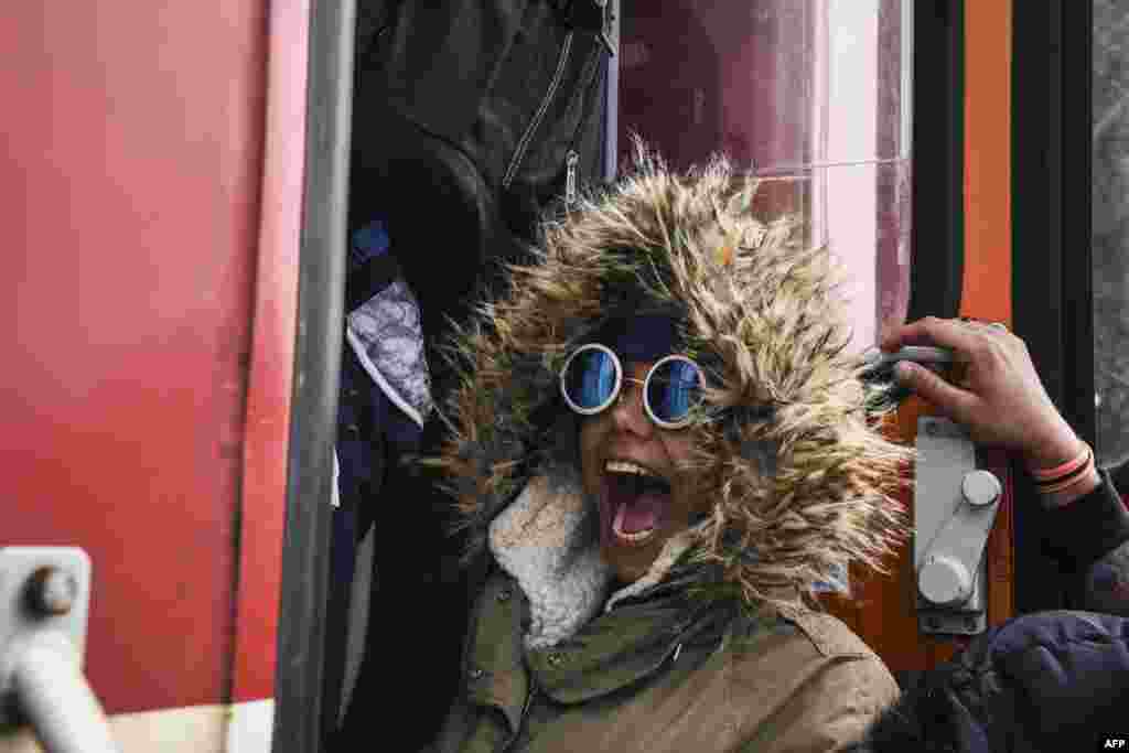 A woman reacts as she boards a train full of migrants and asylum seekers near the Greek-Macedonia border on September 29. (AFP/Armend Nimani)