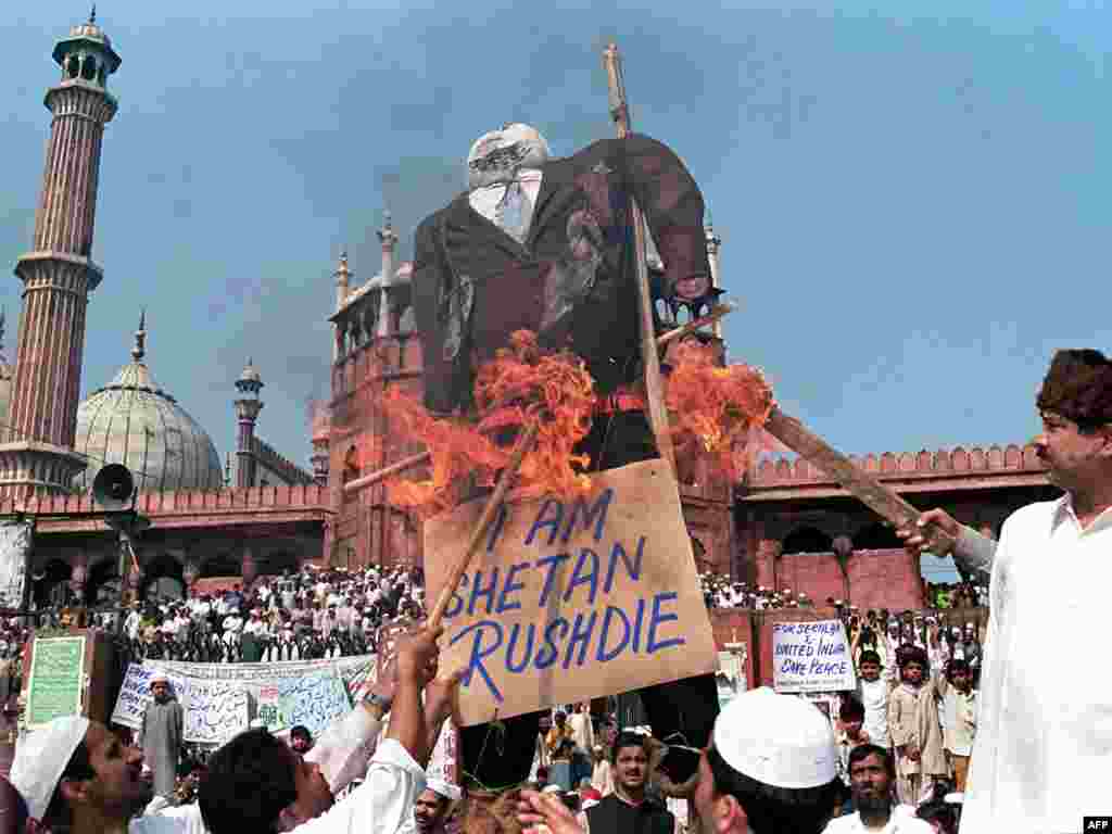 Muslims burn an effigy of Indian-born British author Salman Rushdie as they shout antigovernment slogans during a demonstration near India's largest mosque in New Delhi in February 1999.