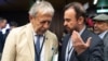 Iran’s ambassador to the International Atomic Energy Agency (IAEA) Reza Najafi (R) and Massimo Aparo, IAEA’s Head of the Department of Safeguards, speak upon arrival for the IAEA’s Board of Governors meeting at the agency's headquarters in Vienna, Austria