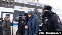 Police detain a participant of the Municipal Russia conference in Moscow on March 13.