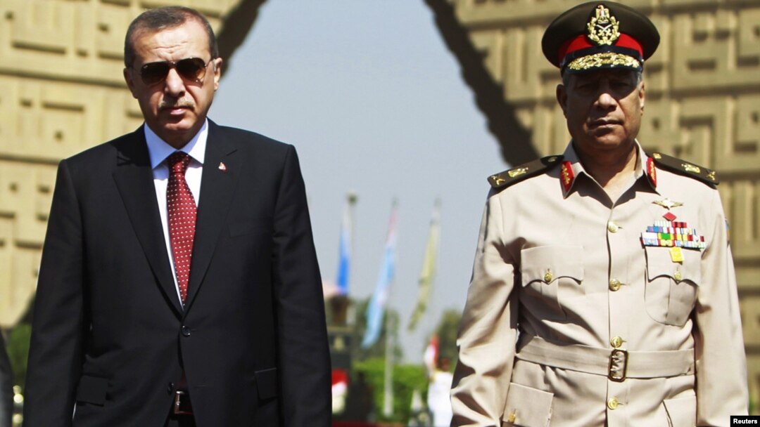 Turkish Prime Minister Recep Tayyip Erdogan (left) pays a visit to the tomb of the late former President Anwar al-Sadat's in Cairo with Egyptian army commander General Hassan al-Roweny.