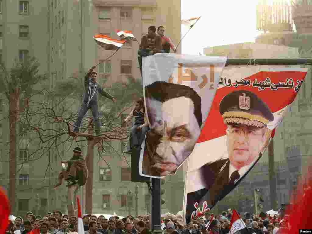 Protesters wave flags as they chant antigovernment slogans during mass demonstrations in Tahrir Square on February 8.