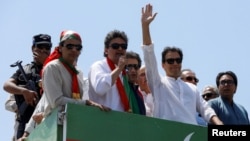 Former Pakistani Prime Minister Imran Khan waves as leads a protest march to Islamabad in Mardan, Pakistan, on May 25.