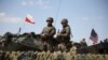 POLAND - Polish and American soldiers stand during Defender Europe 2022 military exercise of NATO troops at the military range in Bemowo Piskie, May 24, 2022.