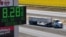 A truck in California drives a past sign showing fuel prices. (file photo)