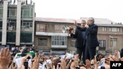 Presidential candidate Mir Hossein Mousavi (R), addressing his supporters during a massive rally on Tehran's Imam Khomeini square, Tehran, June 18, 2009