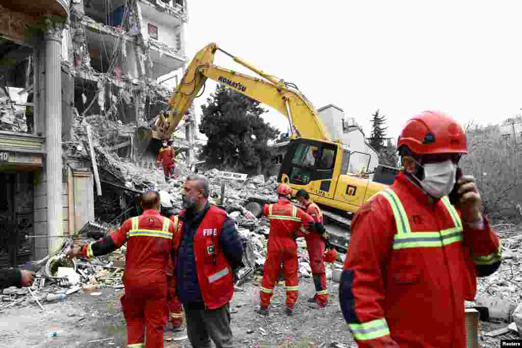 An emergency crew works at the site of a strike on a residential building in Tehran on March 23.