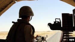 A member of the Afghan security force takes position during an operation against the Taliban in Sangeen district of Helmand Province in July 2016.