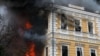 People trying to escape the fire caused by a Russian drone strike at Ukraine's Academy of Sciences building on September 28.