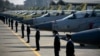 Pakistani Air Force personnel stand guard in front of 14 JF-17B multirole aircraft at a ceremony in 2020.