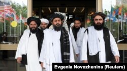 FILE: Members of a Taliban delegation, led by chief negotiator Mullah Abdul Ghani Baradar (center, front), leave after peace talks with Afghan senior politicians in Moscow in May 2019. 