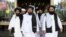Members of a Taliban delegation, led by chief negotiator Mullah Abdul Ghani Baradar (center), leave after peace talks with Afghan politicians in Moscow in May.