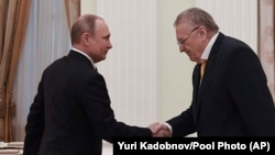 Zhirinovsky shakes hands with President Vladimir Putin in 2018. He ran against Putin for president in 2000, 2012, and 2018.
