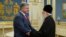 Ukrainian President Petro Poroshenko (left) meets with Patriarch Filaret, head of the Ukrainian Orthodox Church of the Kyiv Patriarchate, in Kyiv on October 11.