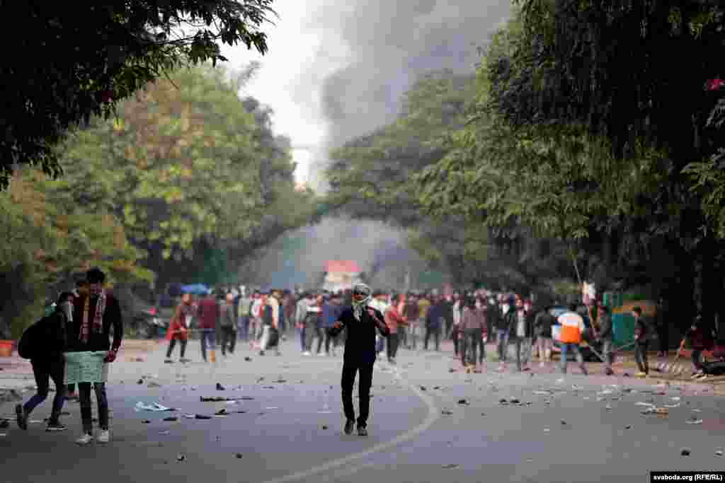 Demonstrators hurl stones towards police during a protest in New Delhi on December 15.