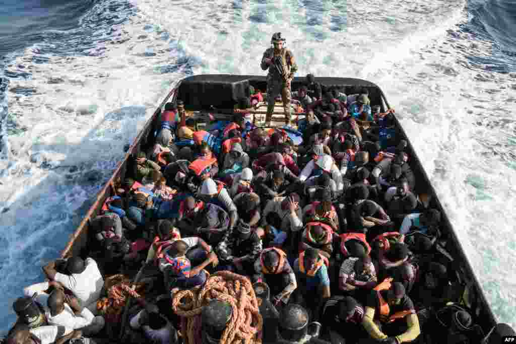 A Libyan coastguard stands on a boat during the rescue of 147 illegal immigrants attempting to reach Europe off the coastal town of Zawiyah, 45 kilometres west of Tripoli, on June 27. (AFP/Taha Jawashi)