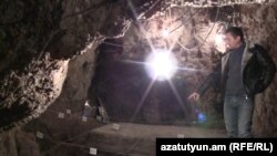 Armenia -- Armenak Melkonian, a guard at an archaeological cave complex in the southeastern Vayots Dzor province, points to the oldest known wine-making facility in the world, 12Jan2010.